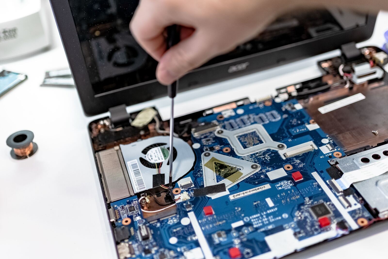 Hands repairing an electronic device